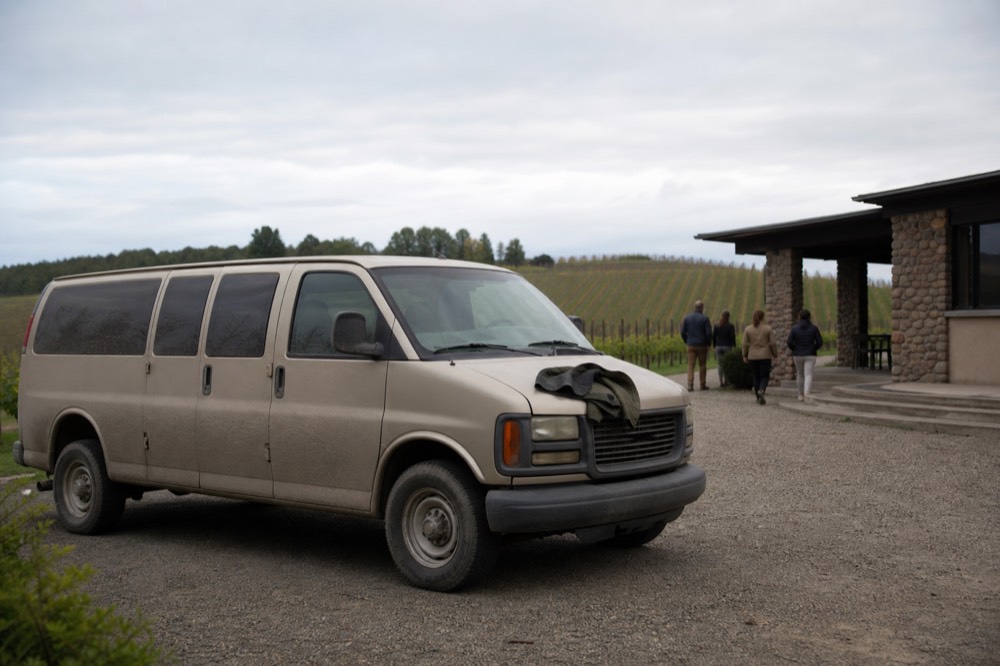 Tour van parked outside a winery in Valle de Guadalupe, no text, no logos, no people