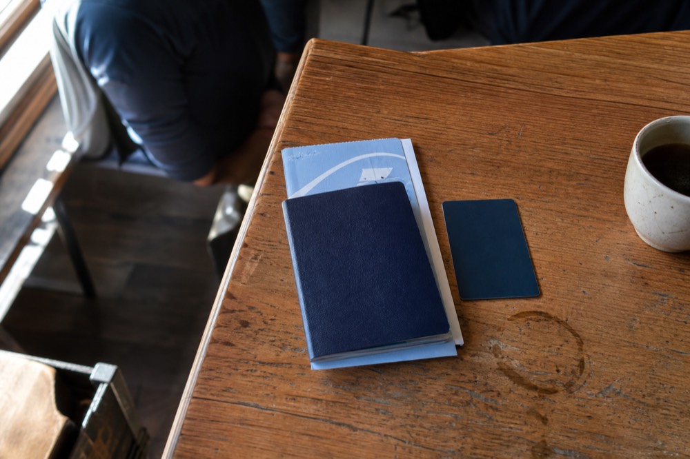 Passport book and passport card side by side, no text, no logos, no people