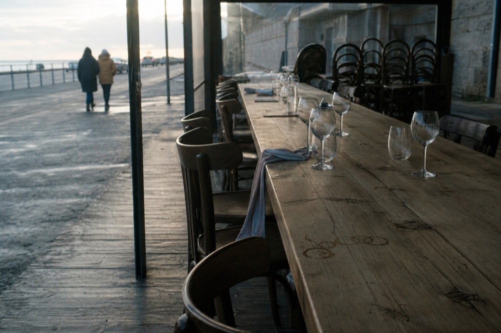 A long table set with empty wine glasses ready for a tasting, no text, no logos, no people