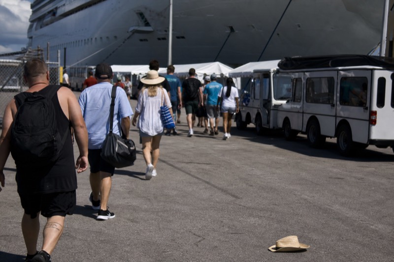 Cruise ship passengers walking toward shuttles at the Ensenada port