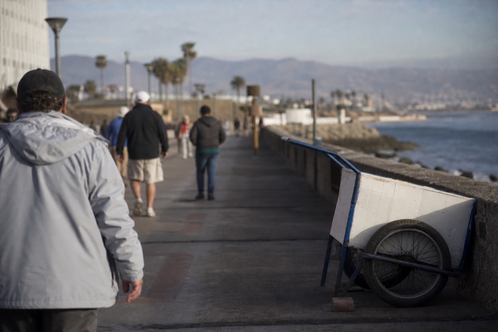 Passengers walking along the Ensenada waterfront near the cruise terminal, no text, no logos, no people