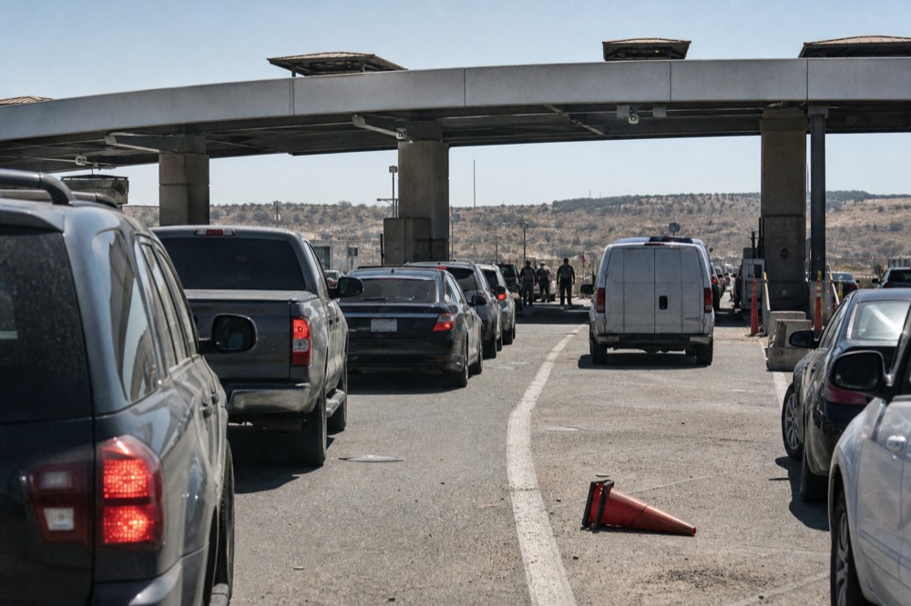 A border crossing checkpoint with vehicle lanes, no text, no logos, no people